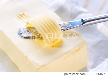 knife slicing through butter close up. knife slicing through butter close up. 115666874