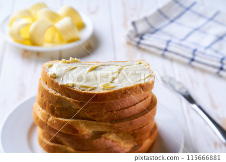 Stack of bread slices with butter, on a kitchen table selective focus. Stack of bread slices with butter, on a kitchen table selective focus. 115666881