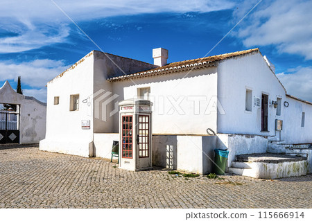 The fishing village Cacela Velha in southern Portugal. White facades of houses with colored decorations. The fishing village Cacela Velha in southern Portugal. White facades of houses with colored decorations. 115666914
