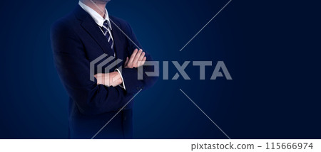 Businessman in a suit with arms crossed, standing against a dark background. Ideal for business, leadership, and professional concept 115666974