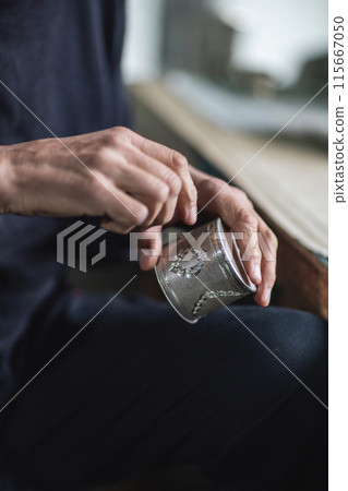 Hands of a jewelry maker at work, close-up. Silver cup holder 115667050
