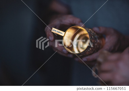 Hands of a jewelry maker at work, close-up. Golden cup holder 115667051