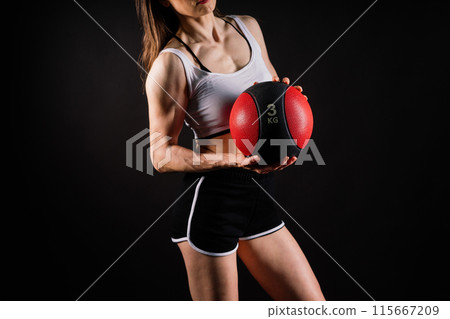 Fitness happy fit woman standing holding a medicine ball. Slim caucasian cross fit woman with fitness ball 115667209