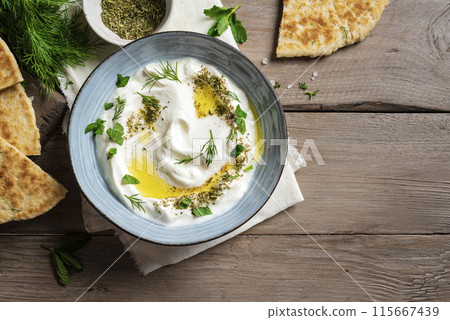 Labneh yogurt cream cheese dip with pita bread Labneh yogurt cream cheese dip with pita bread 115667439