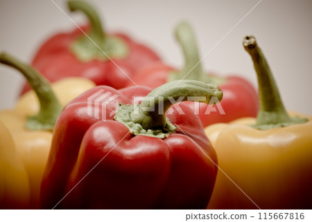 Close up of mixed yellow and red fresh bell peppers Close up of mixed yellow and red fresh bell peppers 115667816