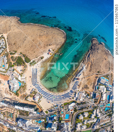 Aerial view of Sandy Bay beach (Vathia Gonia) resort. Ayia Napa, Cyprus 115667863