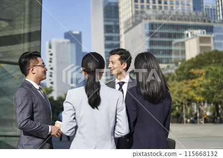 group of asian business people standing chatting on street in downtown group of asian business people standing chatting on street in downtown 115668132