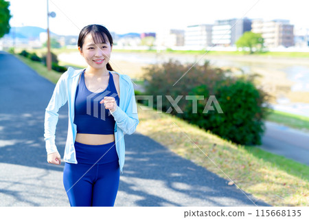 A young woman jogging in the city along the river Bodybuilding Diet A young woman jogging in the city along the river Bodybuilding Diet 115668135