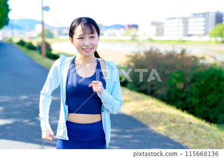 Young woman jogging in the city along the river Body make-up Diet Trimming 115668136