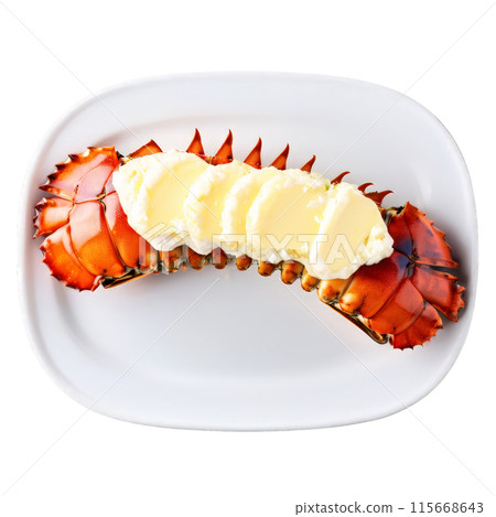 Broiled lobster tail split open garnished with drawn butter shot from above Food and culinary 115668643