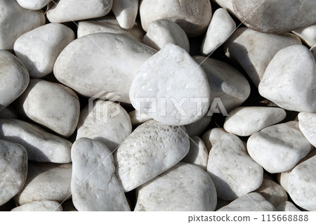 Background - white tumbled marble stones on the coast of a unique sea coast 115668888