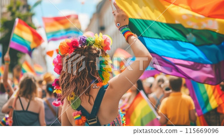 Crowd celebrating with rainbow flags at a public event 115669096