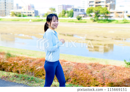 年輕女子在城市沿河慢跑、身體化妝、飲食 年輕女子在城市沿河慢跑、身體化妝、飲食 115669151