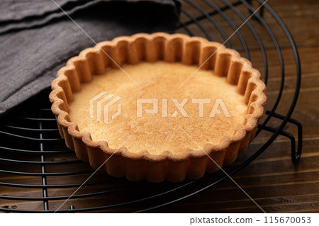 Cookie torte on a cake cooler on a wooden table 115670053
