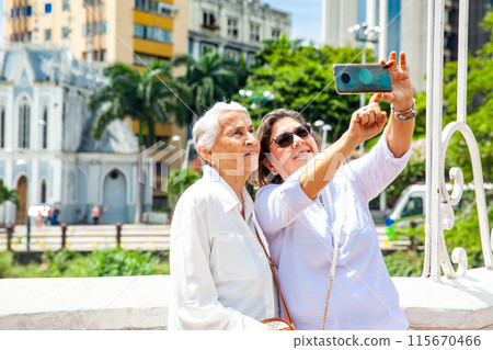 Senior mother and daughter travelling togeher having fun. Senior adults in Cali Colombia. Senior lifestyle. Senior travel. Senior mother and daughter travelling togeher having fun. Senior adults in Cali Colombia. Senior lifestyle. Senior travel. 115670466