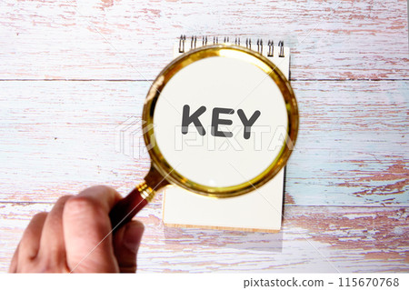 The word key found using a magnifying glass in a notebook 115670768