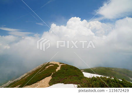 The ridgeline of Mt. Karamatsu in early summer with clouds rising The ridgeline of Mt. Karamatsu in early summer with clouds rising 115672429