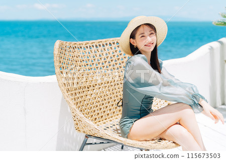 A woman in a swimsuit enjoying vacation at a resort 115673503