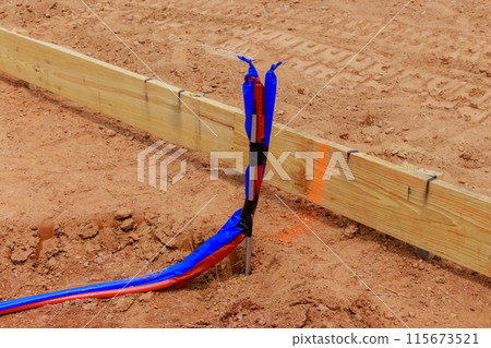 Before pouring concrete in foundation of new home, underground water pipes sanitary pipes must be laid before pouring concrete 115673521