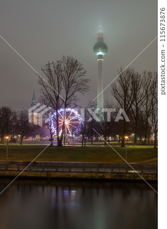 View of Famous Berlin Television Tower, Mary's Church Steeple and Ferris Wheel of Night Christmas Market. 115673876
