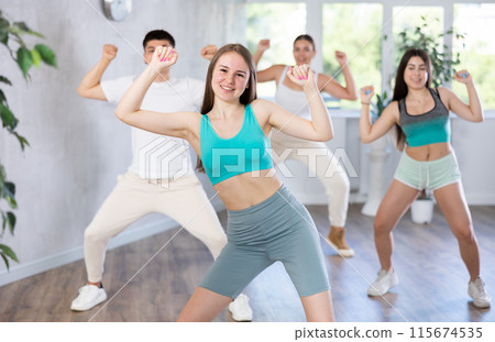 Girl teen perform choreographic exercise and teach energetic house dance with friends Girl teen perform choreographic exercise and teach energetic house dance with friends 115674535
