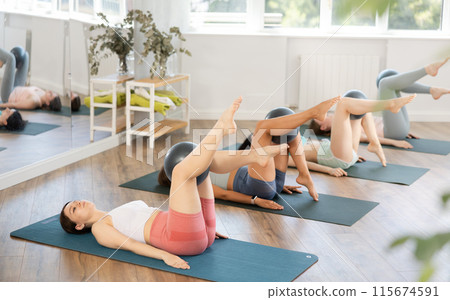 Yoga or Pilates classes with balls for group of women Yoga or Pilates classes with balls for group of women 115674591