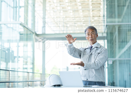 Senior man wearing work clothes 115674627