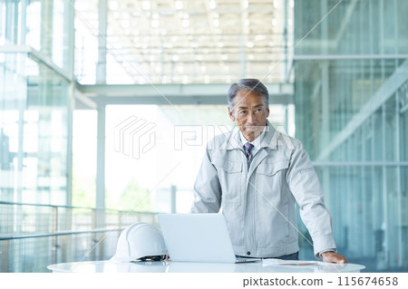 Senior man wearing work clothes 115674658