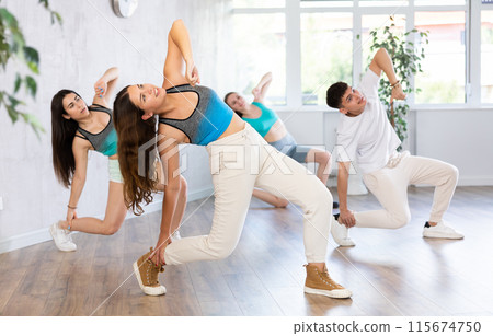 Girl teen perform choreographic exercise and teach energetic house dance with friends 115674750