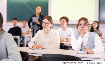 Young girls students study diligently at school Young girls students study diligently at school 115675021