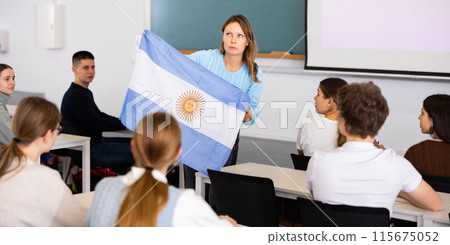 Female professor shows students flag of Argentina Female professor shows students flag of Argentina 115675052