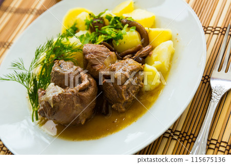 Stewed lamb with potatoes and mushrooms , served at plate Stewed lamb with potatoes and mushrooms , served at plate 115675136