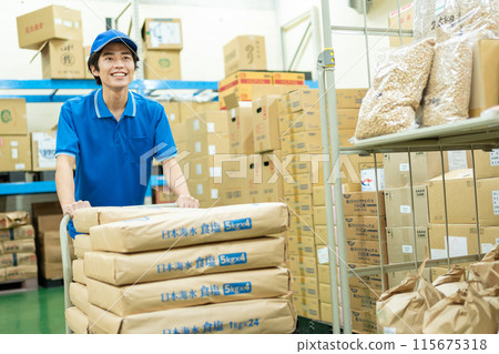 Young male driver working in warehouse Young male driver working in warehouse 115675318