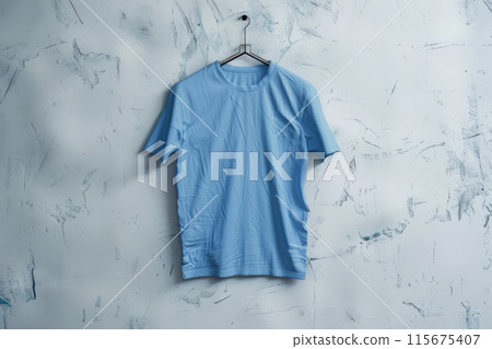 Blue t-shirt on a white textured background Blue t-shirt on a white textured background 115675407