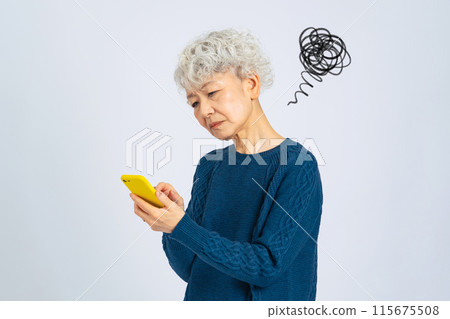 Senior woman feeling disappointed while using a smartphone 115675508