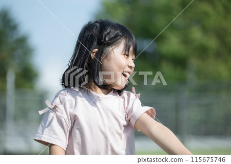 Children dancing happily in the park or on the grass. Image of active children 115675746