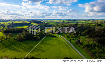 Aerial View of Rolling Hills and Farmlands in Hautes Fagnes, Belgium 115676894