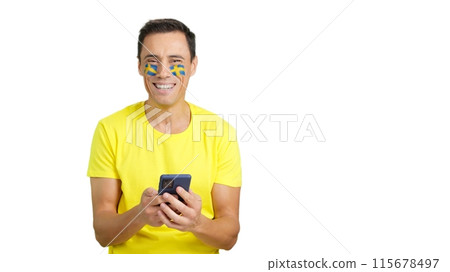 Swedish supporter looking at his mobile smiling and showing it. Swedish supporter looking at his mobile smiling and showing it. 115678497