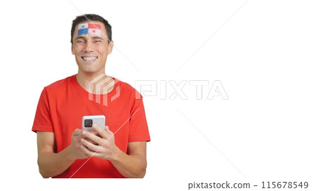 Panamanian supporter looking at his mobile smiling and showing it. Panamanian supporter looking at his mobile smiling and showing it. 115678549