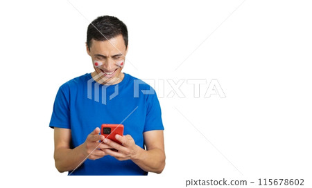 Japan supporter looking at his mobile smiling and showing it. 115678602