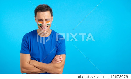 Man standing with indian flag painted on face smiling 115678679