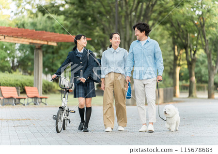 Family of junior high and high school students and their parents walking in the park (dog, pet, daughter, parents, 3 people) 115678683