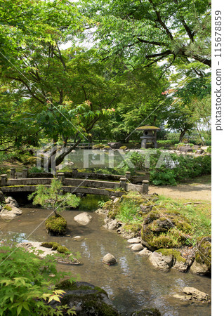 A stone bridge over a babbling brook, bonsai trees on stones and a sandbank, Japanese garden, Akita Prefecture A stone bridge over a babbling brook, bonsai trees on stones and a sandbank, Japanese garden, Akita Prefecture 115678859