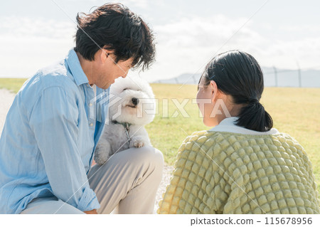 A dog-loving family walking their dog, father, daughter, parent and child 115678956
