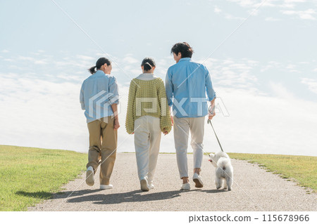 Family (parents and child, 3 people) playing with dog/pet/walking Family (parents and child, 3 people) playing with dog/pet/walking 115678966