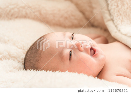 Baby sleeping on a fluffy blanket 115679231