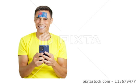Australian supporter looking at his mobile smiling and showing it. 115679477
