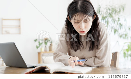 A woman studying for a qualification at home A woman studying for a qualification at home 115679817