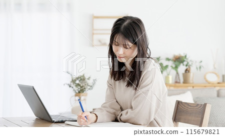 A woman studying for a qualification at home 115679821