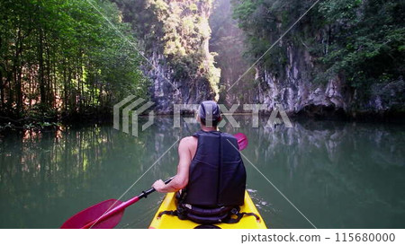 Man leisurely navigates kayak admiring wild nature Man leisurely navigates kayak admiring wild nature 115680000